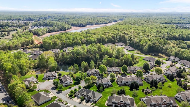 bird's eye view featuring a forest view and a residential view