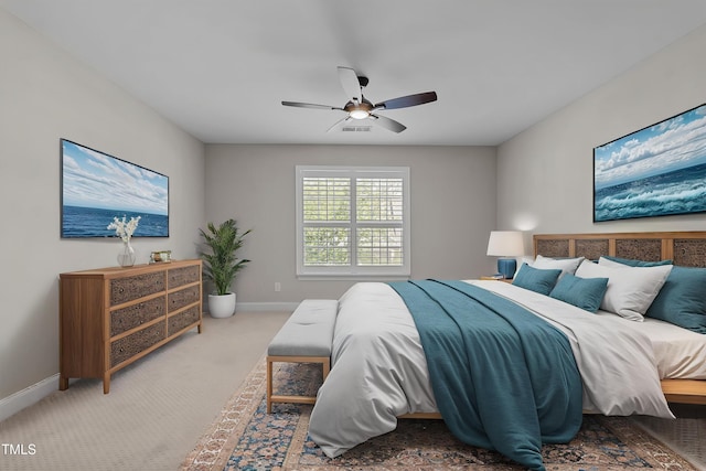 carpeted bedroom featuring visible vents, a ceiling fan, and baseboards