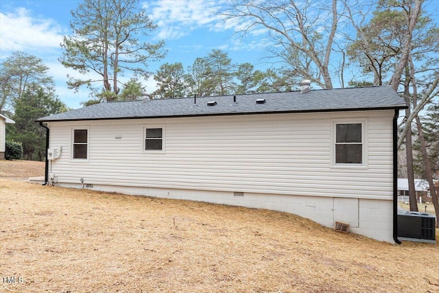 view of property exterior featuring central air condition unit and a yard