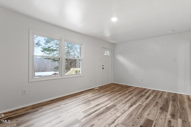 spare room featuring light hardwood / wood-style flooring