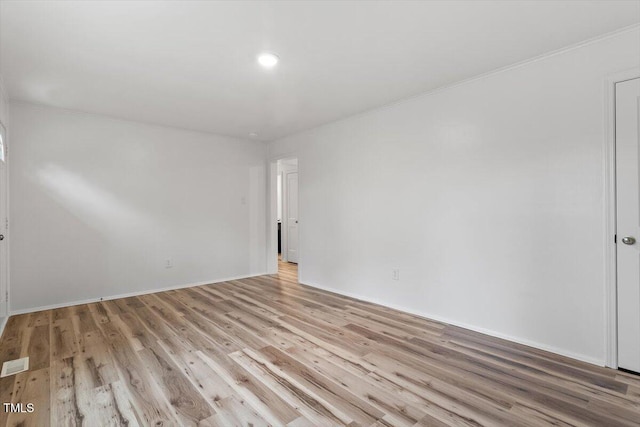 empty room with light hardwood / wood-style flooring