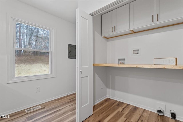 laundry room featuring light wood-type flooring, washer hookup, cabinets, and electric dryer hookup