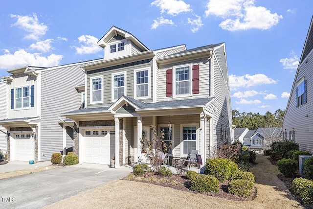 view of front of property with a garage, driveway, central AC unit, and a porch