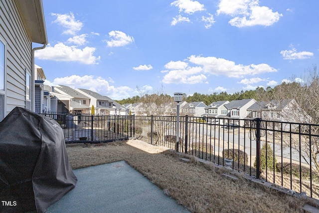 view of yard featuring a balcony and a residential view