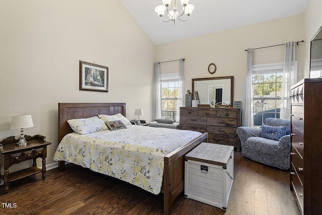 bedroom with dark wood-style floors, high vaulted ceiling, and a notable chandelier