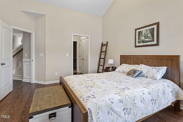 bedroom featuring vaulted ceiling, dark wood finished floors, and baseboards