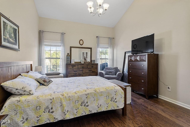 bedroom with multiple windows, baseboards, vaulted ceiling, and wood finished floors