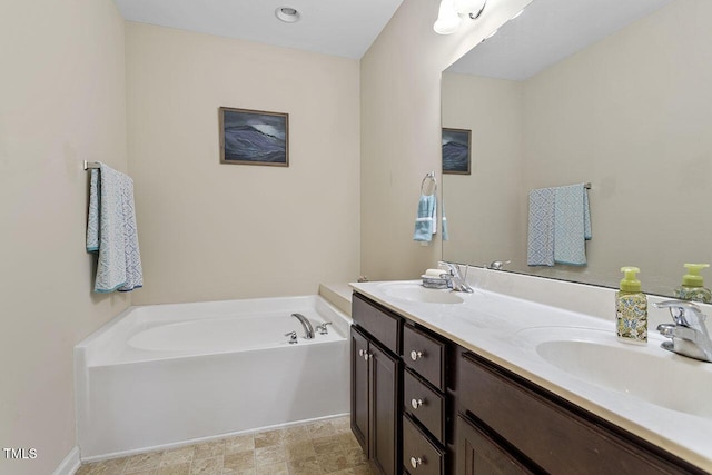 bathroom featuring a garden tub, a sink, and double vanity