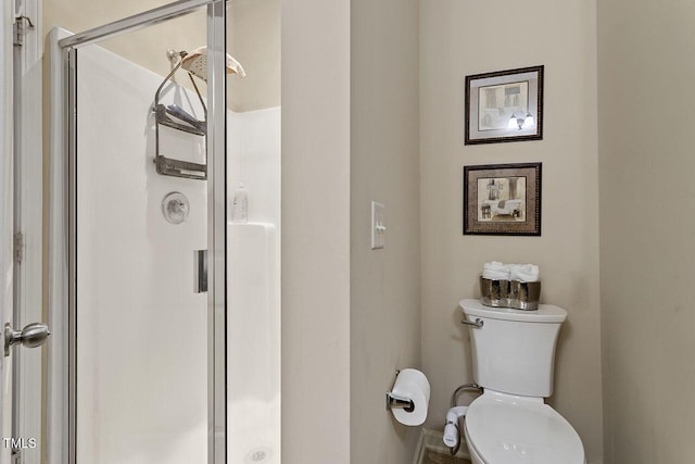 full bathroom with toilet and a stall shower