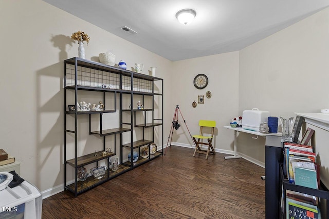 office area with visible vents, baseboards, and wood finished floors