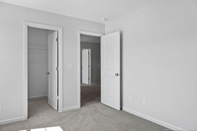 821 Tori Dr, Spring Lake, NC 28390 - unfurnished bedroom with carpet floors, baseboards, a spacious closet, and a closet