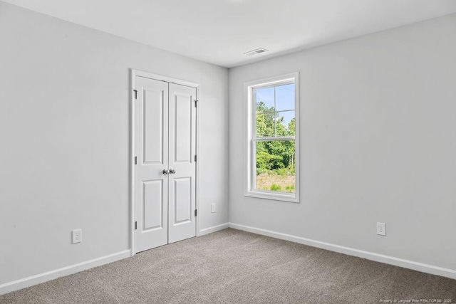 821 Tori Dr, Spring Lake, NC 28390 - unfurnished bedroom with baseboards, carpet floors, and a closet