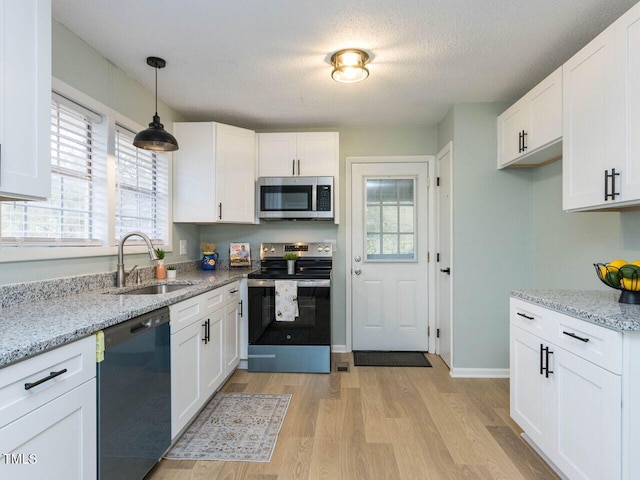 kitchen with white cabinetry, sink, and appliances with stainless steel finishes