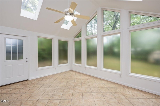 unfurnished sunroom featuring a ceiling fan and vaulted ceiling with skylight