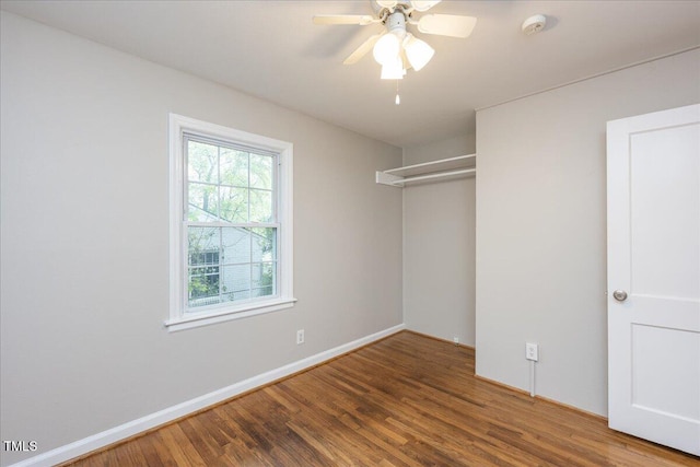 unfurnished bedroom with a ceiling fan, a closet, baseboards, and wood finished floors