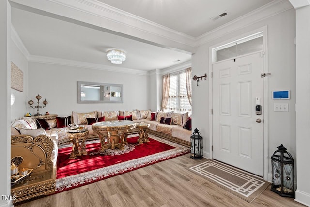 living room with wood-type flooring and crown molding