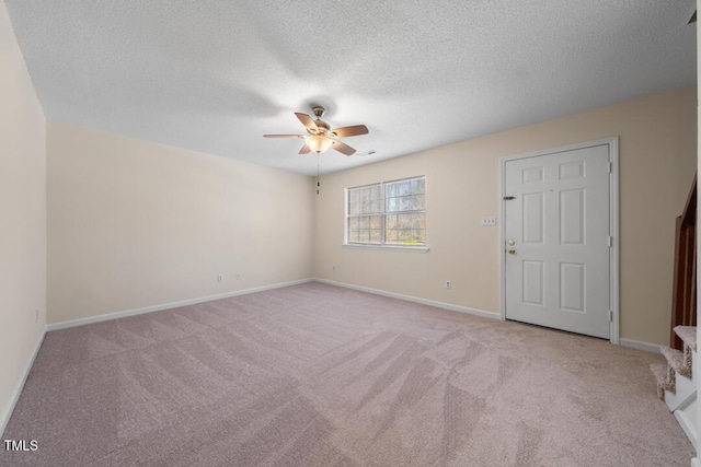 unfurnished room with light carpet, a textured ceiling, and ceiling fan