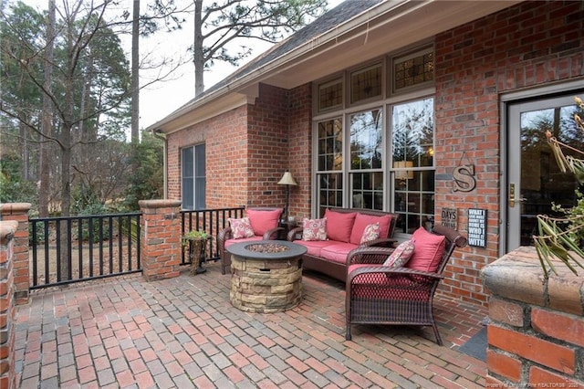 view of patio / terrace featuring an outdoor living space with a fire pit