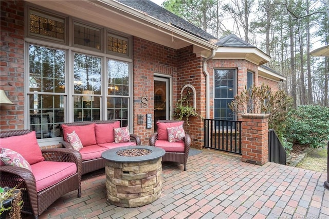 view of patio / terrace with an outdoor living space with a fire pit