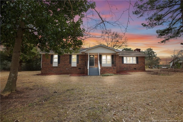 ranch-style home with a porch and a yard