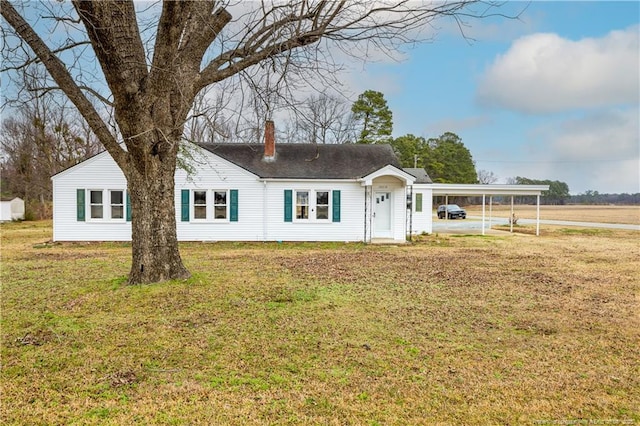 single story home with a front yard and a carport