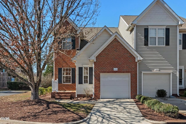 view of front of home with a garage, concrete driveway, and brick siding