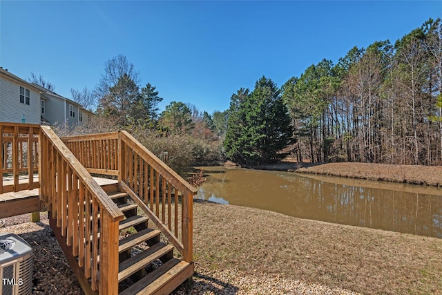 view of yard featuring cooling unit, a water view, and stairway