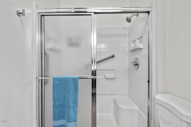 full bath featuring toilet and an enclosed shower