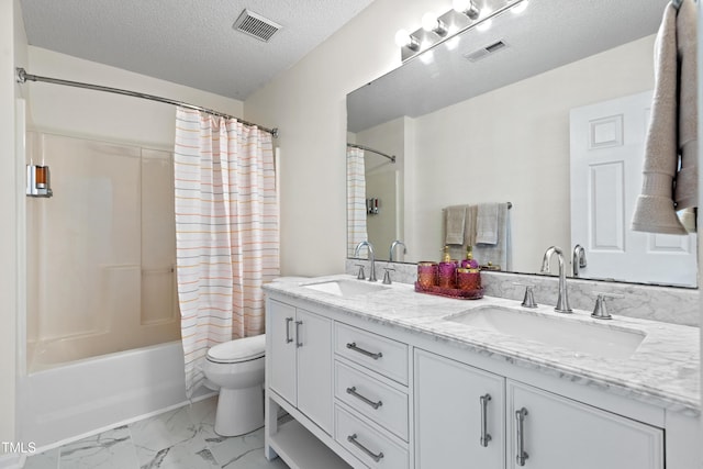 bathroom featuring marble finish floor, visible vents, shower / bath combo with shower curtain, and a sink