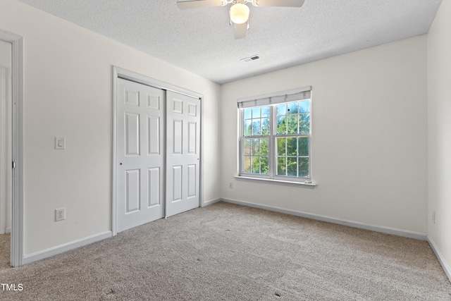 unfurnished bedroom featuring carpet floors, a closet, visible vents, and baseboards