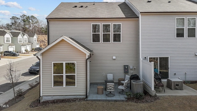 rear view of house featuring a patio and central air condition unit