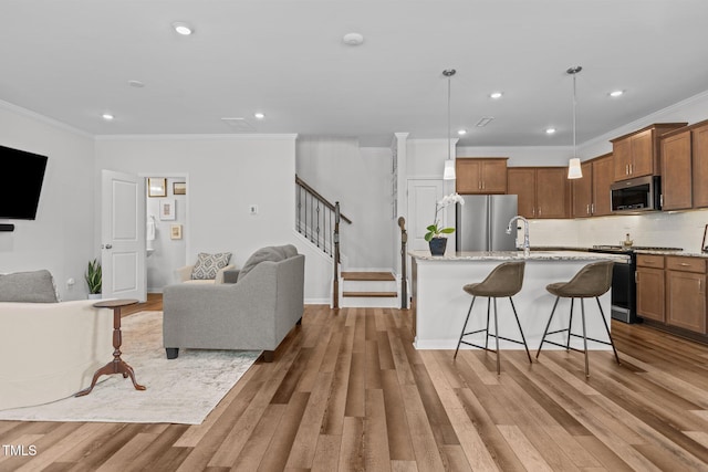 living room with hardwood / wood-style floors and ornamental molding