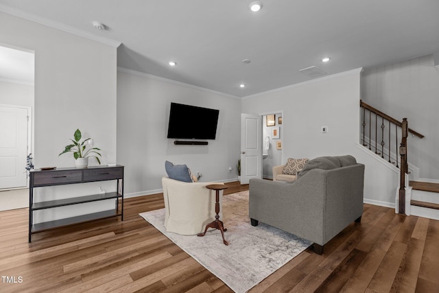 living room featuring hardwood / wood-style flooring and ornamental molding