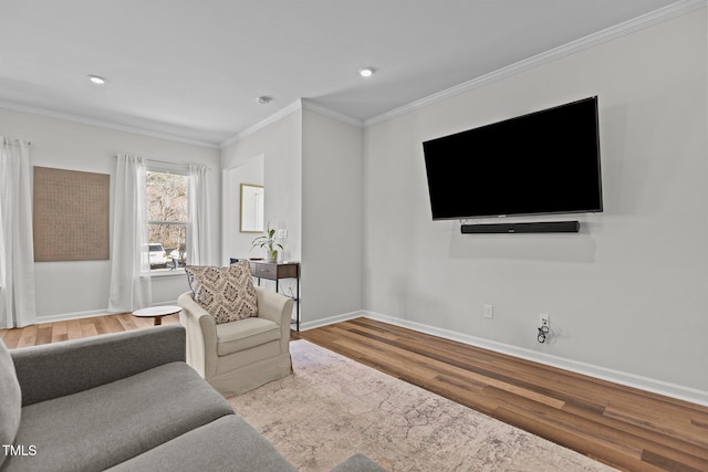 living room with ornamental molding and light hardwood / wood-style flooring