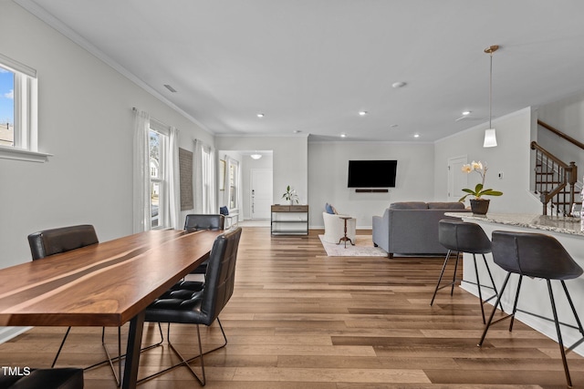 dining room featuring hardwood / wood-style flooring and ornamental molding