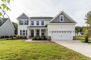 view of front of home with a garage and a front lawn