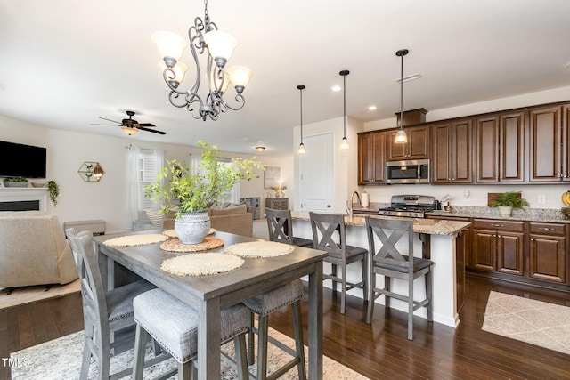 dining room featuring recessed lighting, visible vents, dark wood-type flooring, and ceiling fan with notable chandelier