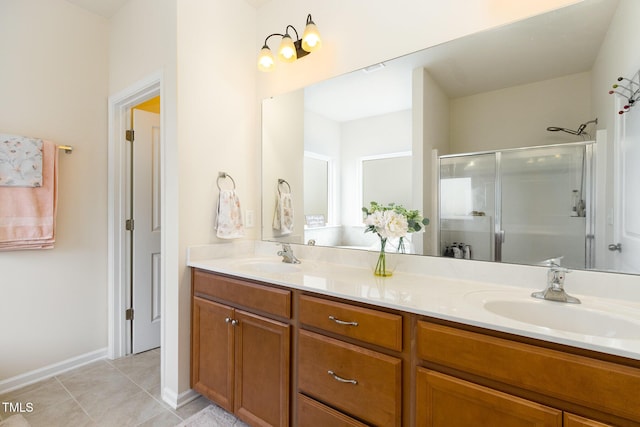 full bath featuring double vanity, tile patterned flooring, a shower stall, and a sink