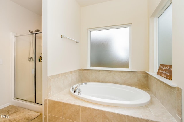 full bathroom with a garden tub and a shower stall