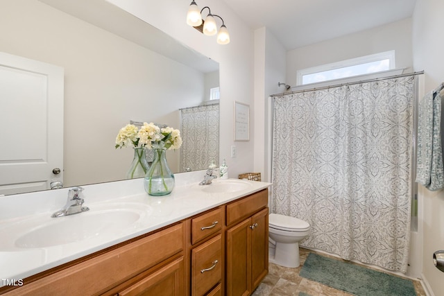 full bath featuring toilet, shower / tub combo, double vanity, and a sink