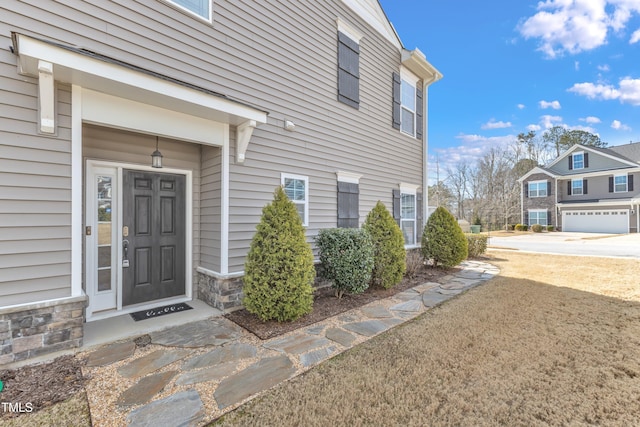 doorway to property with stone siding