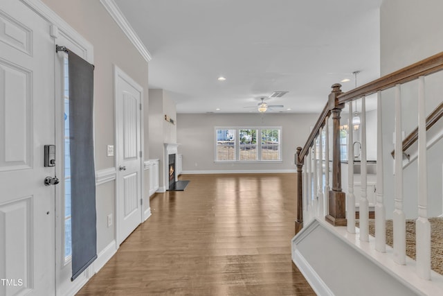 entrance foyer featuring a fireplace with flush hearth, ceiling fan, stairway, wood finished floors, and recessed lighting