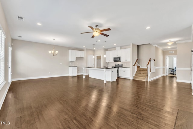 unfurnished living room featuring baseboards, visible vents, dark wood-style flooring, and ceiling fan with notable chandelier