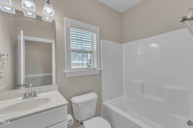 bathroom with shower / tub combination, vanity, and toilet