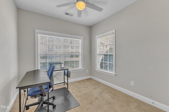 carpeted home office featuring ceiling fan, visible vents, and baseboards