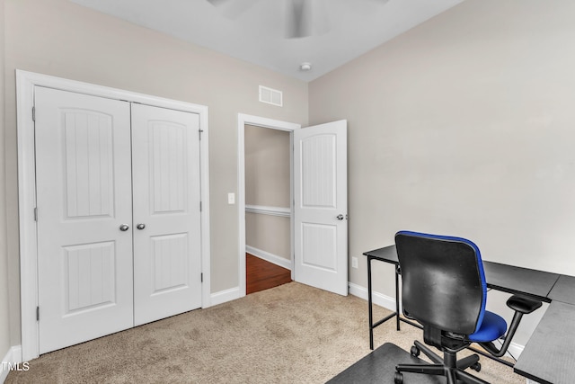 carpeted home office featuring ceiling fan, visible vents, and baseboards