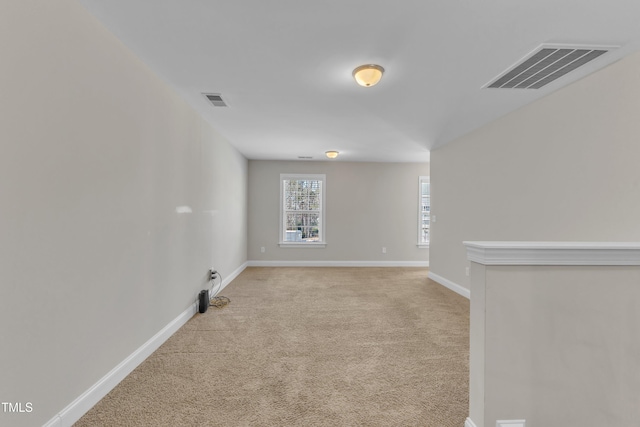 empty room with light carpet, baseboards, and visible vents