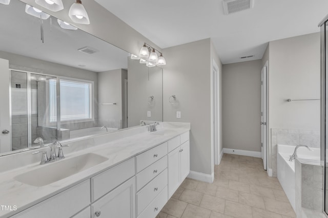 full bathroom with visible vents, a sink, a bath, and double vanity