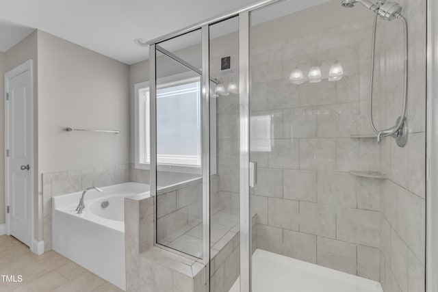 bathroom featuring a stall shower and a garden tub