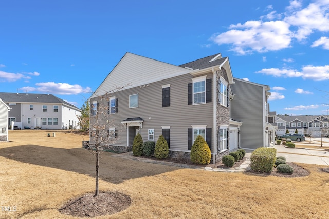 view of front of house with a residential view and a front lawn